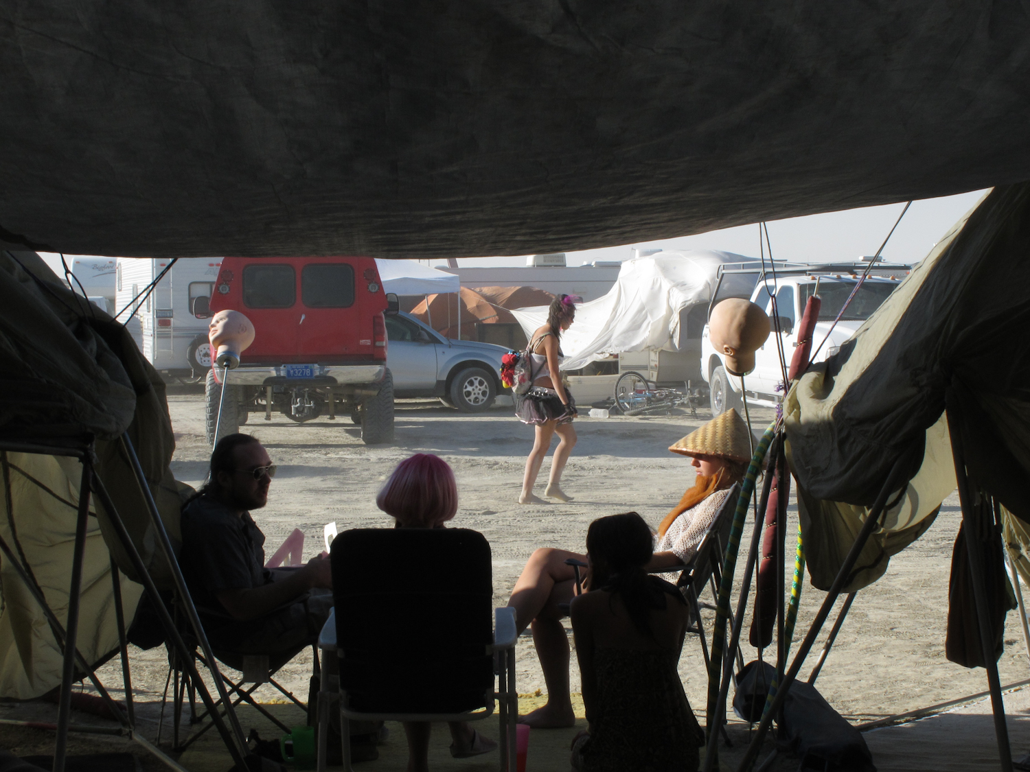 a group of people sitting in chairs underneath a tent