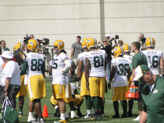 green bay packers huddle together before a game