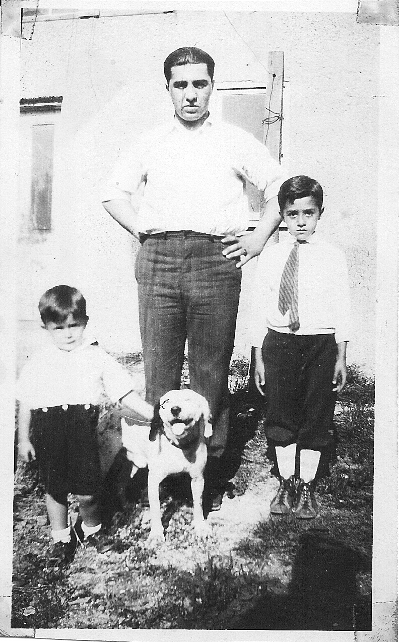 an old black and white po shows an old man standing between two boys