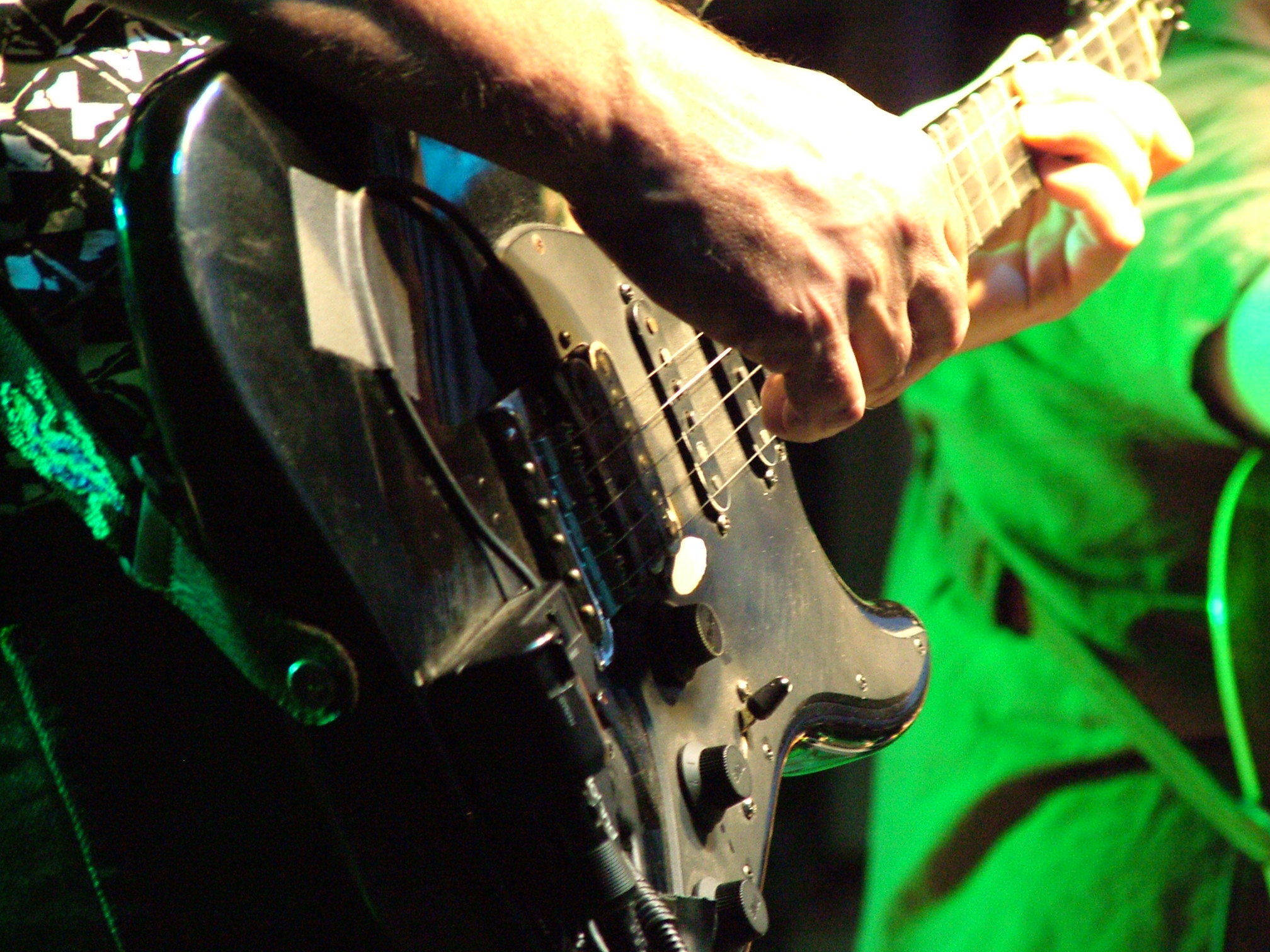 a man holding an electric guitar in his right hand