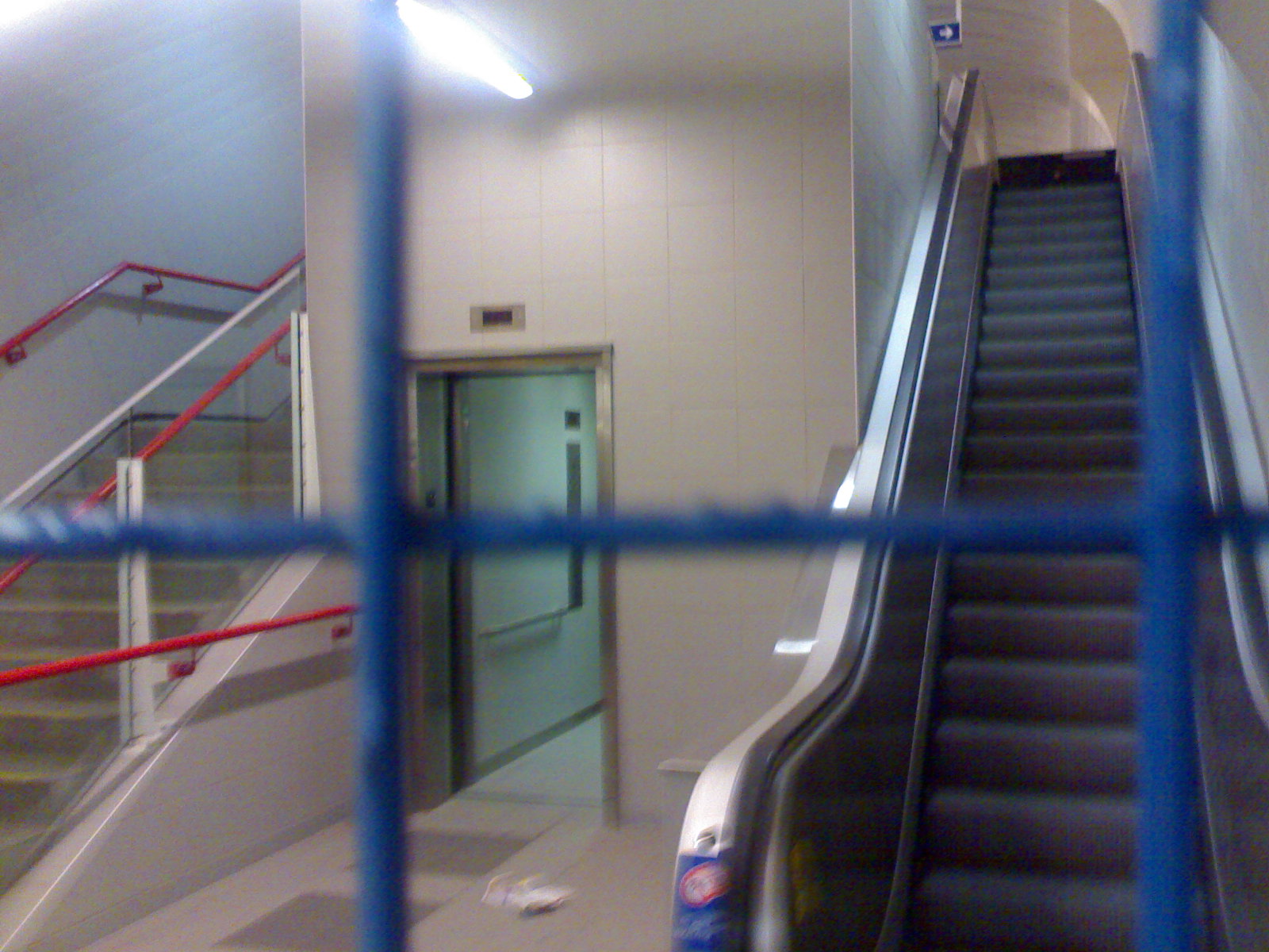 an escalator leading to a second story on the other side of the building