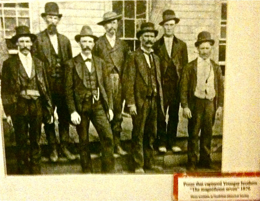 the men are standing in front of a house