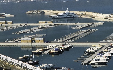 boats in a marina, one on the far end and the other off