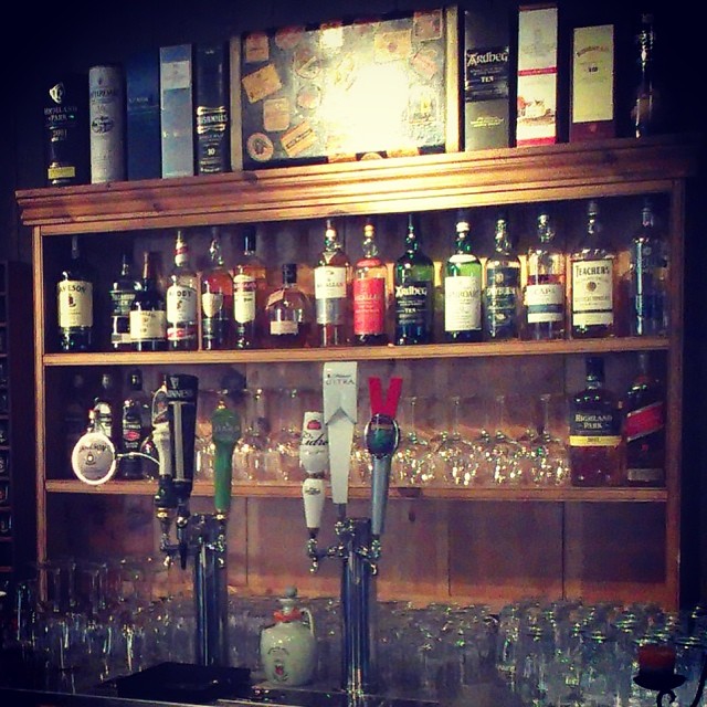 a bar with several liquor bottles behind it