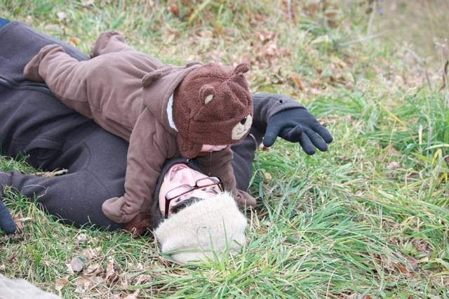 a stuffed bear is on its back in the grass