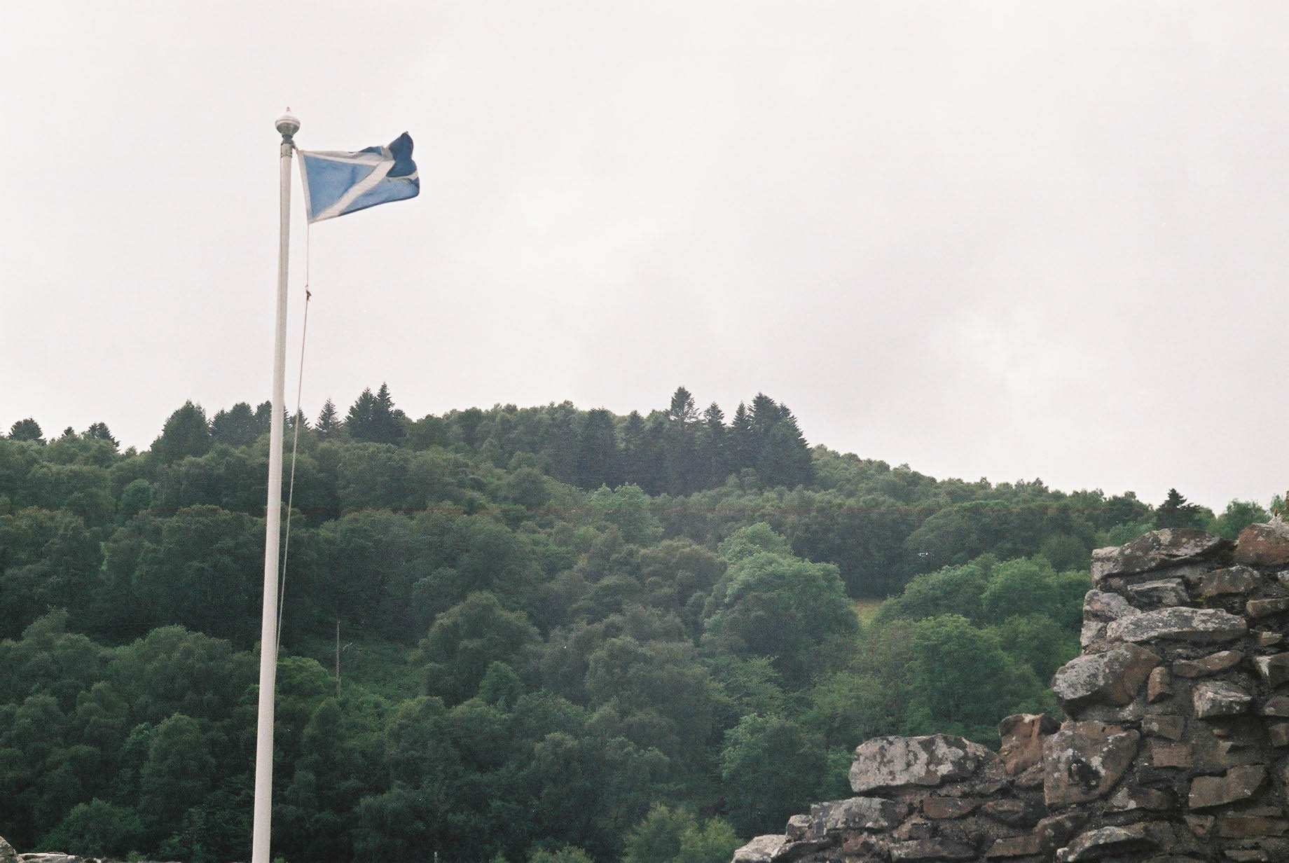 there is a flag flying at the top of a mountain