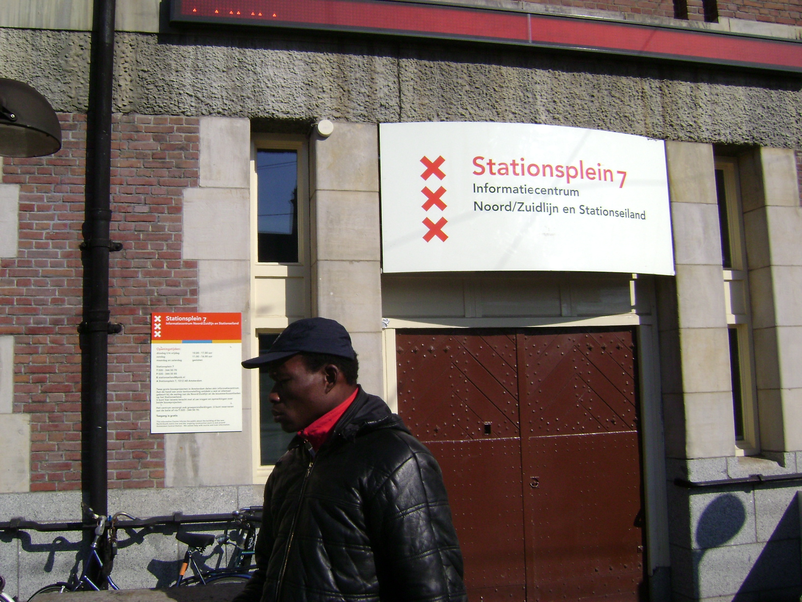 a man is walking by a building in an urban setting