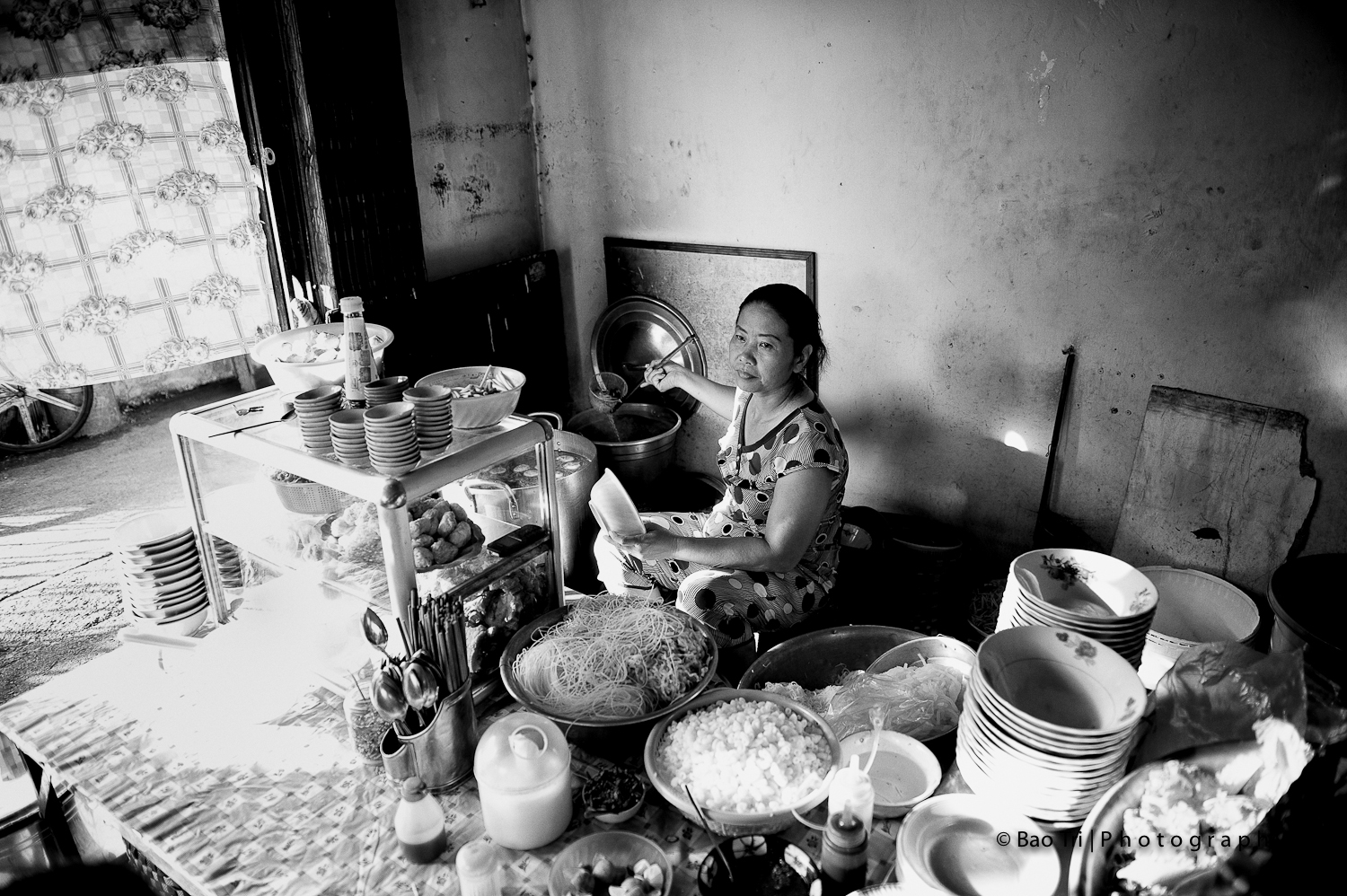 a woman sitting down on a chair in front of a table full of food