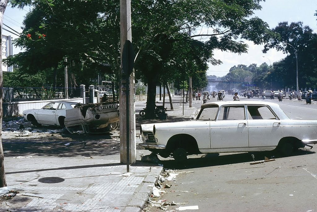 old cars parked next to the side of the road