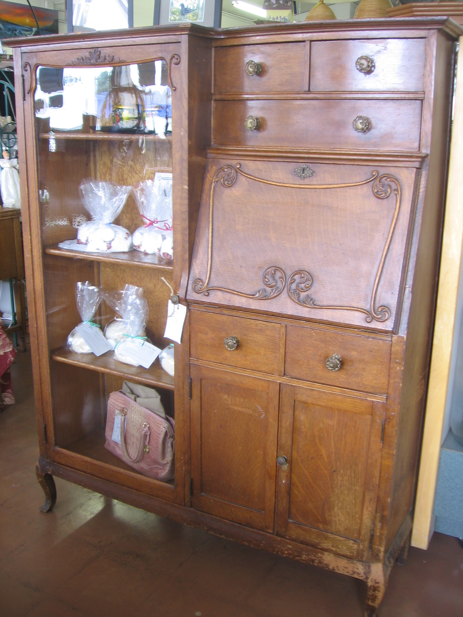 a wooden dresser with an old fashioned display case