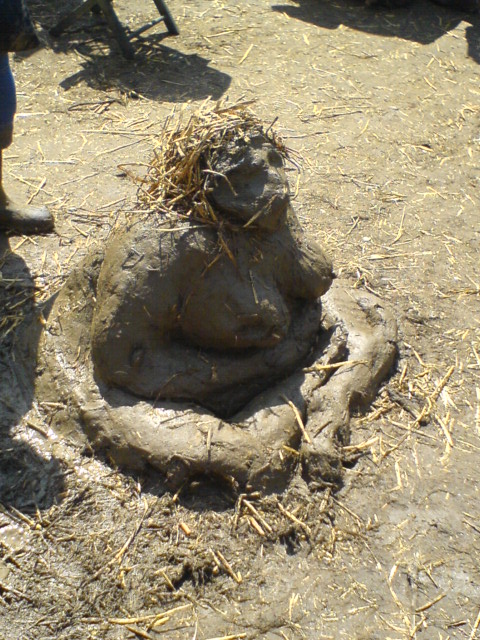 a clay face made out of straw on a farm
