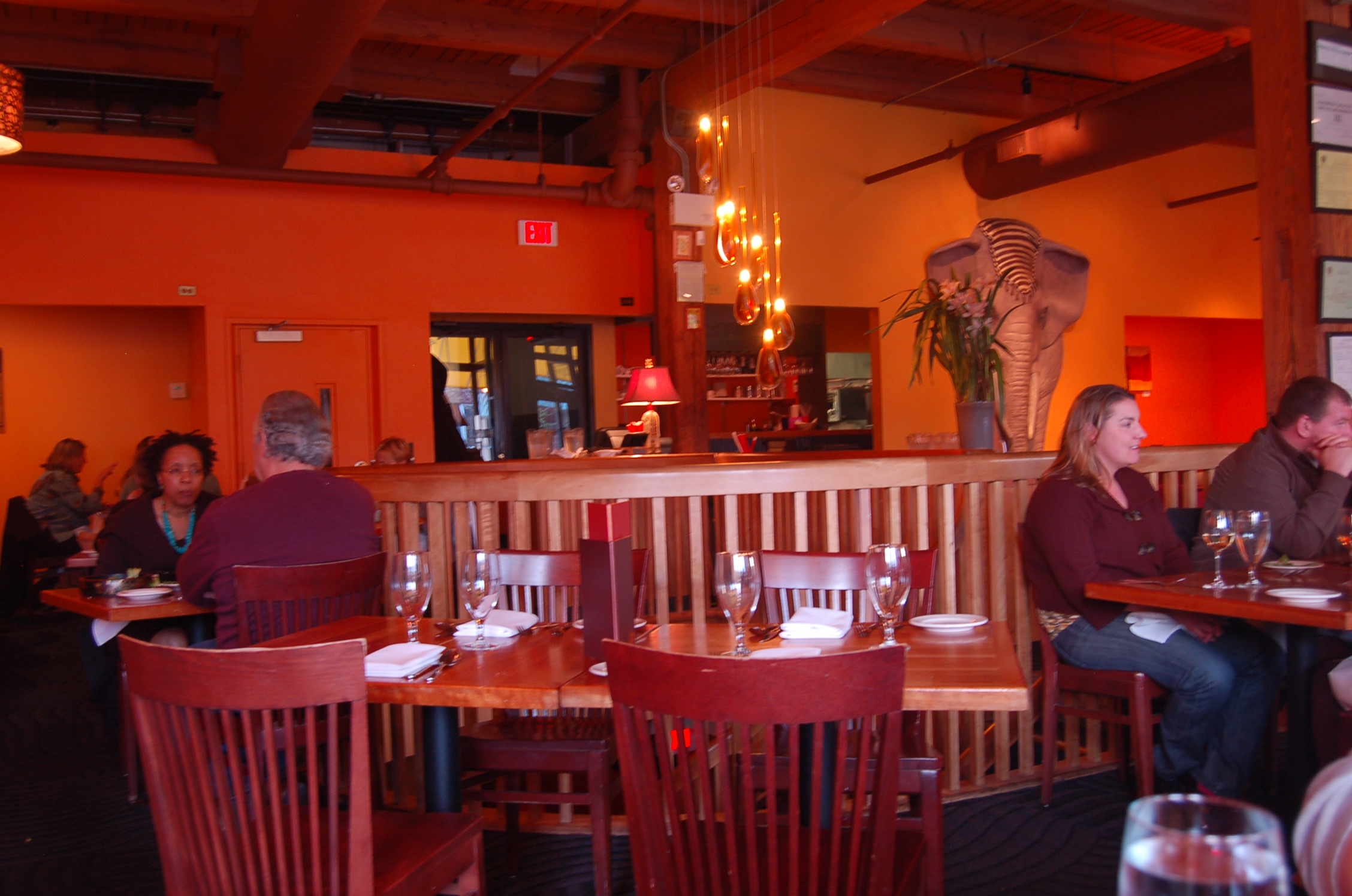 a restaurant with many wooden tables and chairs