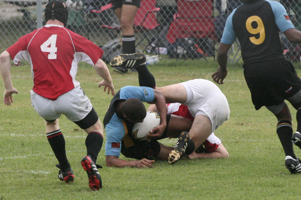 several players from two teams collide on each other as they fight in soccer