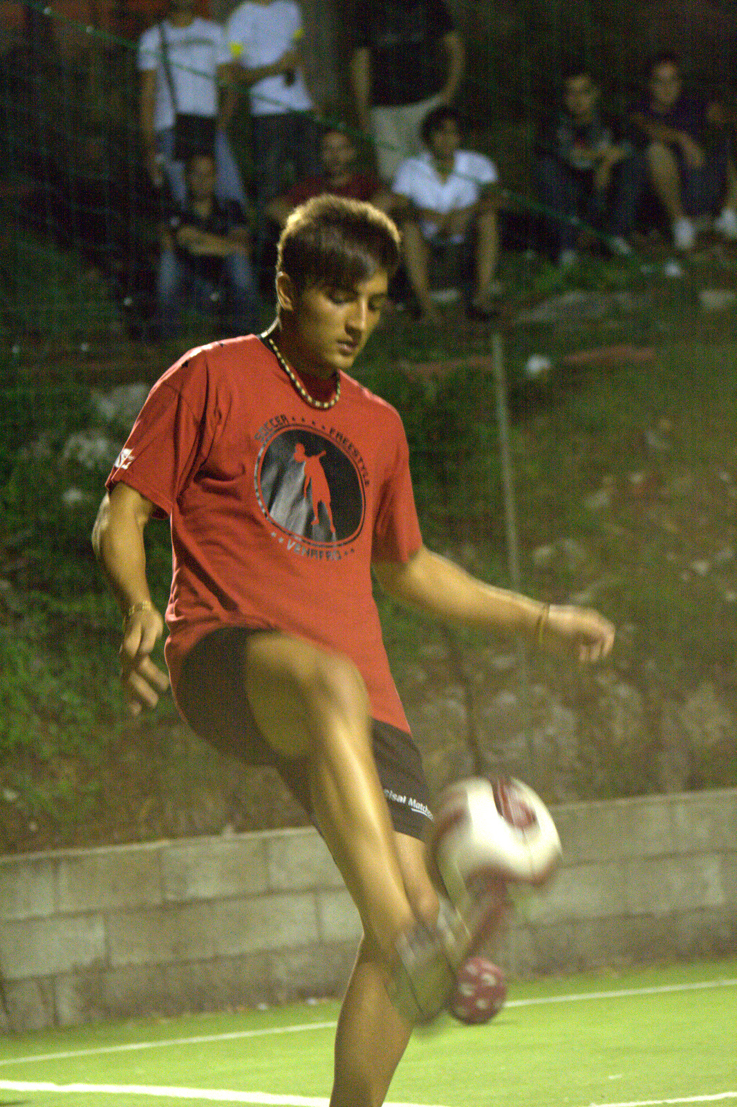 a man in a red shirt playing soccer