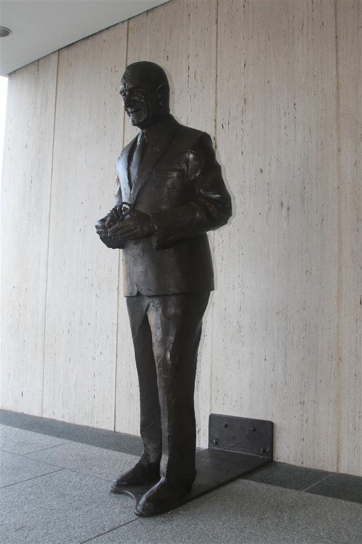 a large metal statue of a man is in the corner