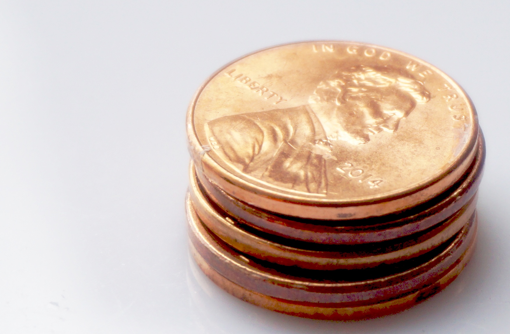 a stack of five golden lincoln halves