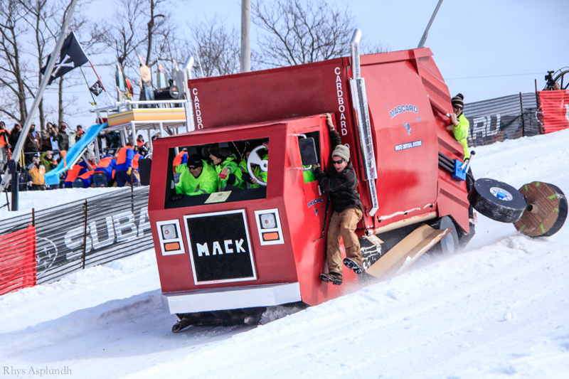a man climbing out of an ice machine in a ski slope