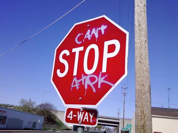a stop sign that has graffiti on it