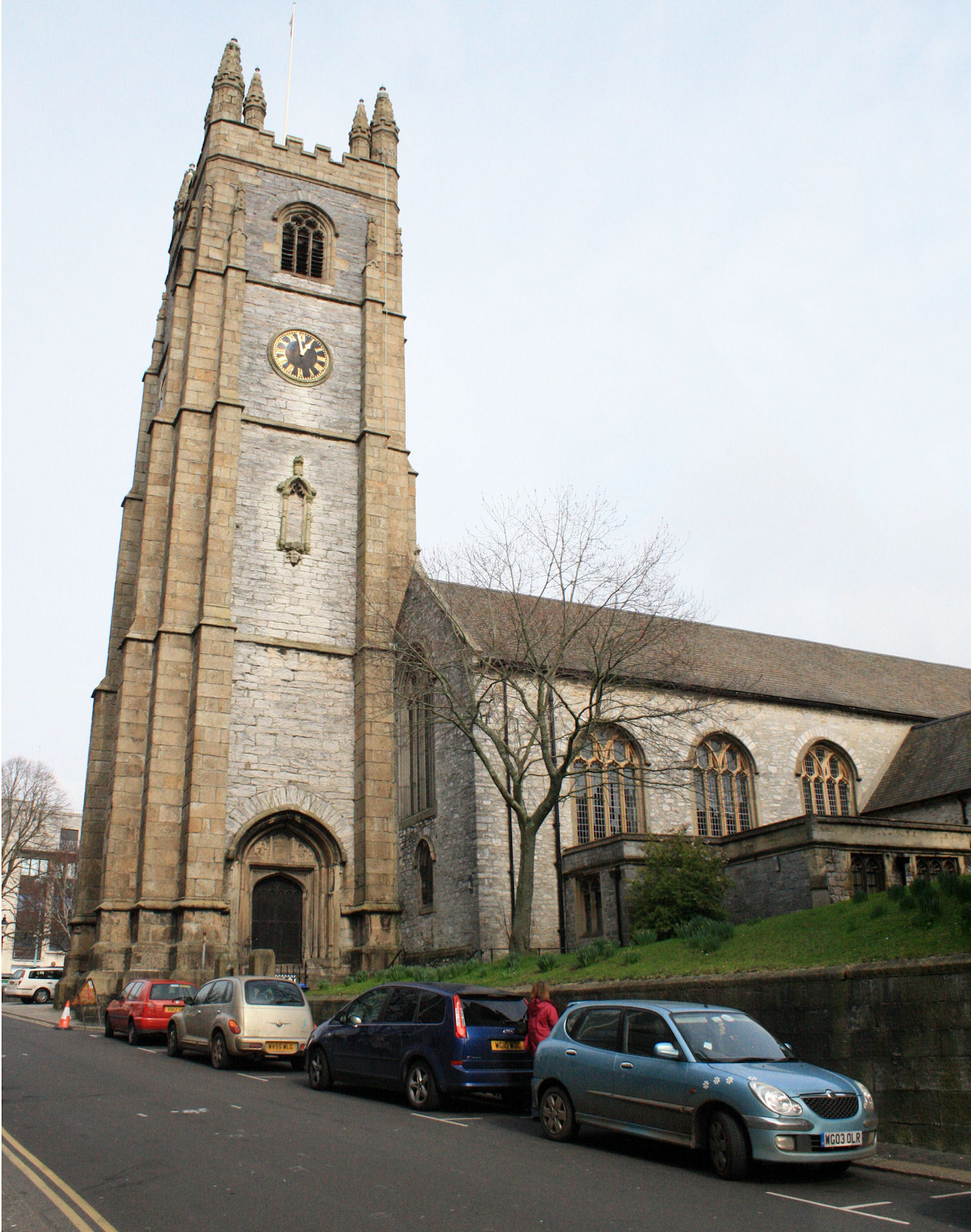 some cars are parked in front of a large church