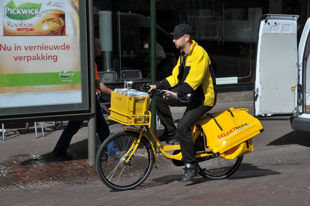 a man is riding a small bike with a cart