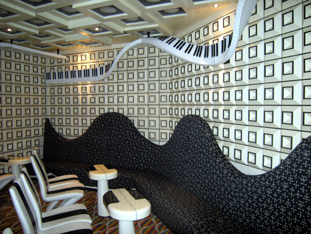 some chairs and tables on display with a piano theme