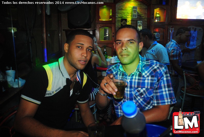 two young men having drinks at a bar
