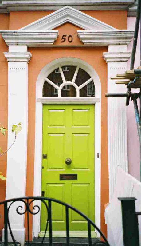 bright green door in front of orange and white building