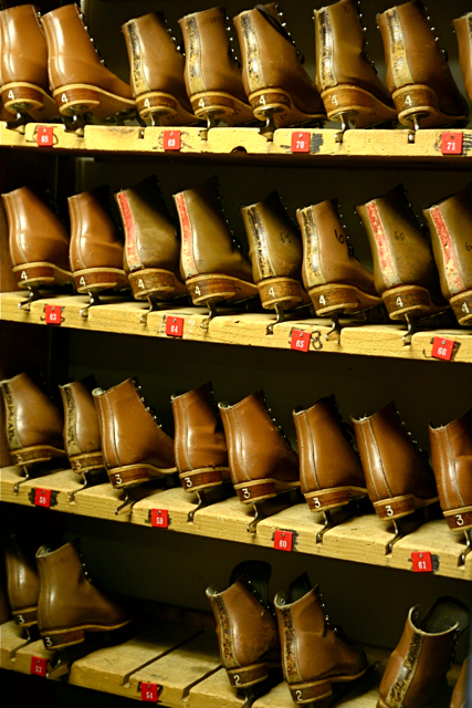 a shelf full of pairs of leather shoes