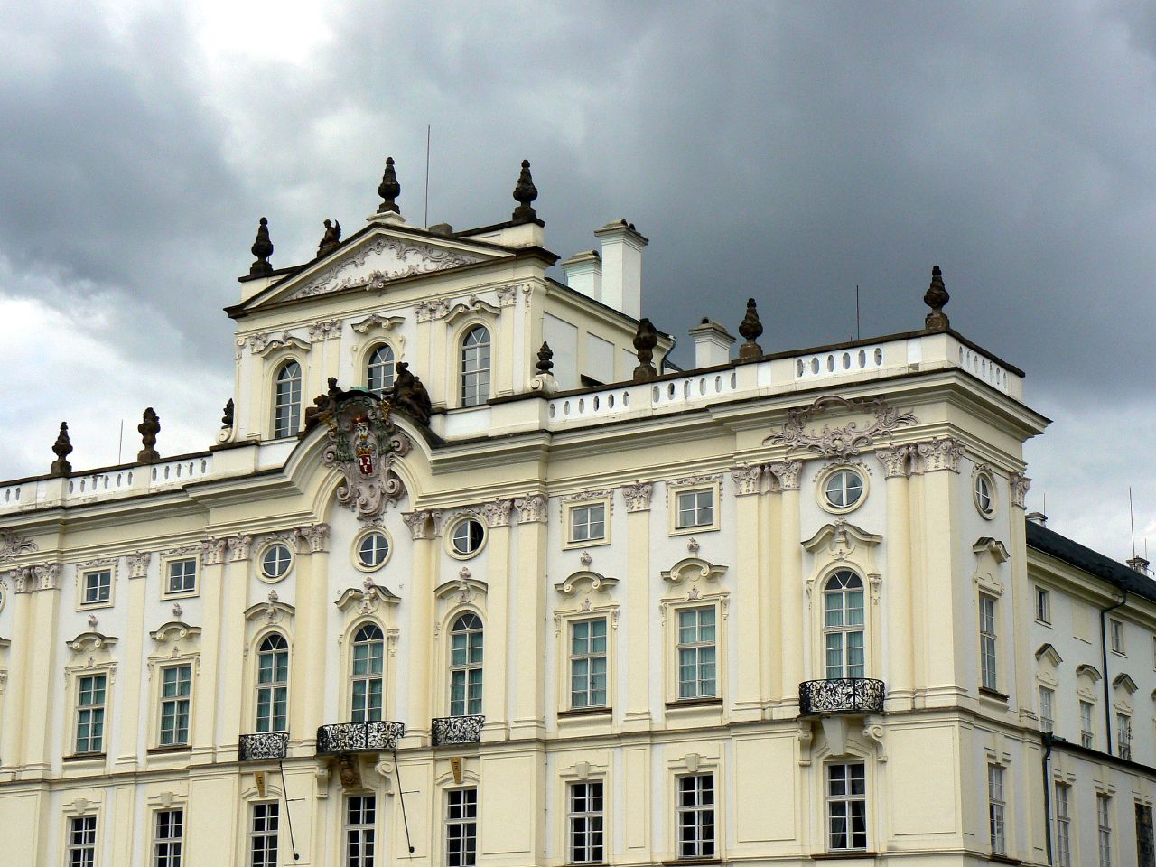 an architectural building with an intricate roof and balcony