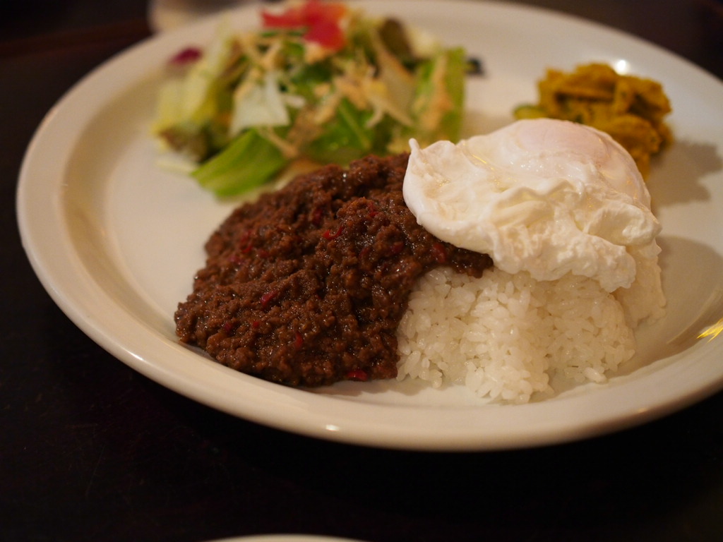 a white plate topped with food and greens