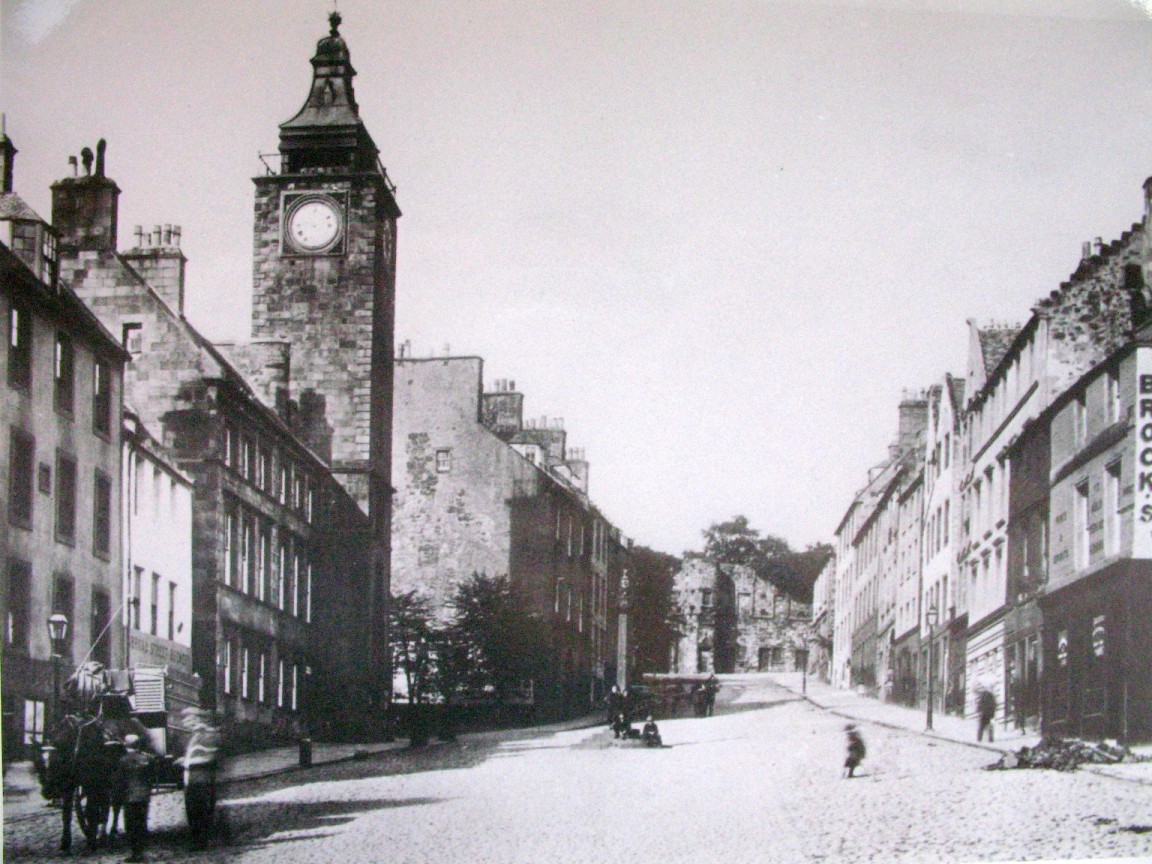 old time street with a clock tower in the background
