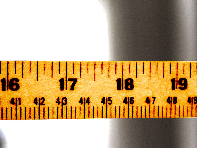 a yellow tape measure with black numbers is shown