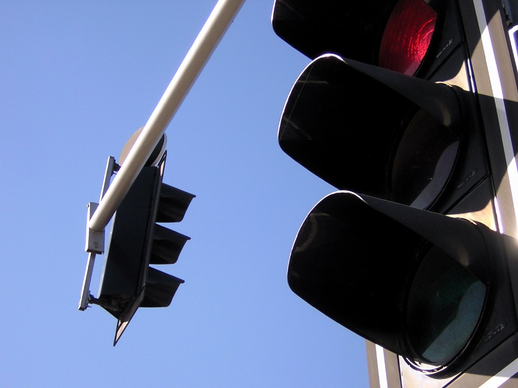 the light on the pole is red and shows a red signal