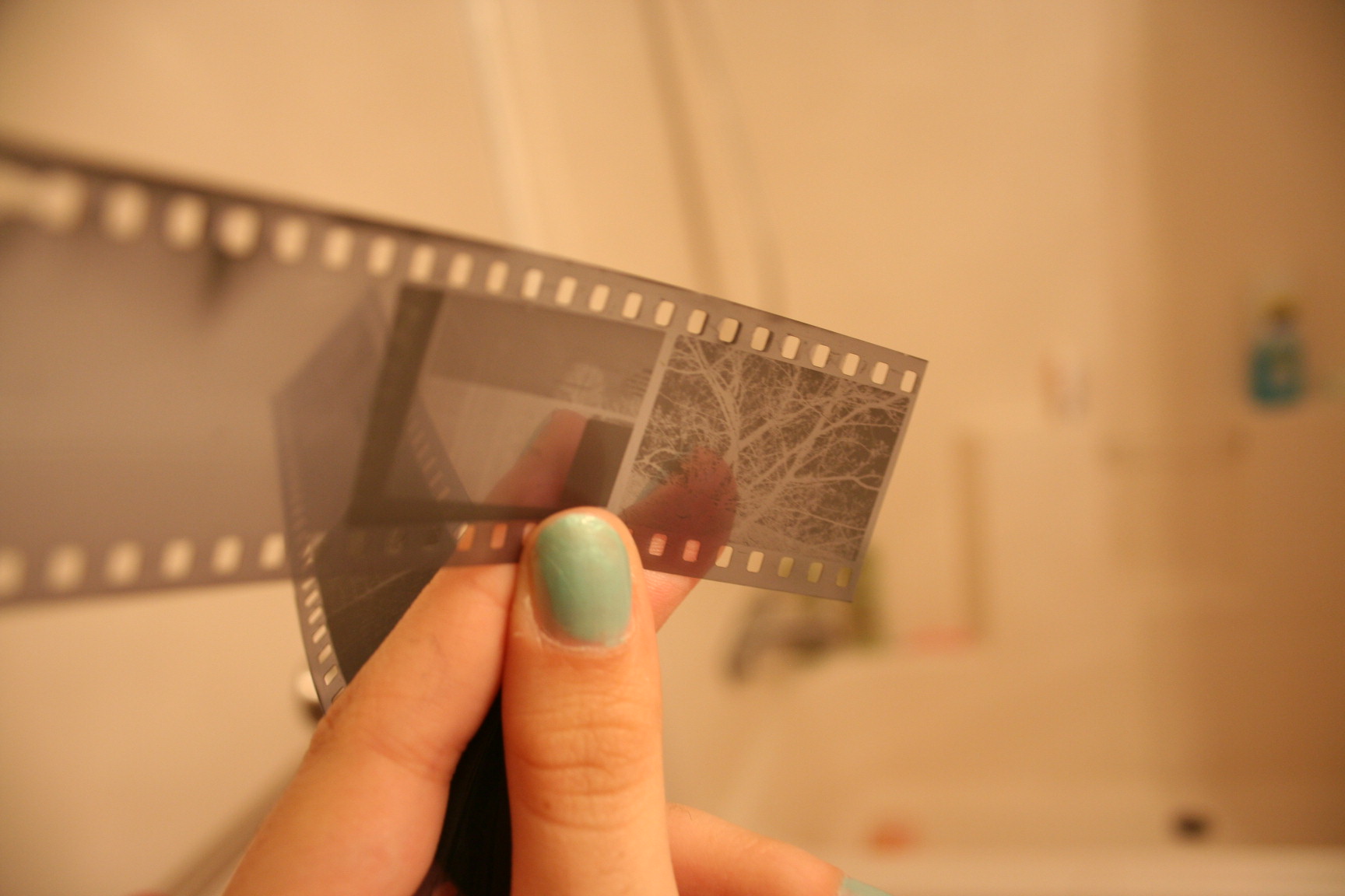 a woman's hand holding a film strip