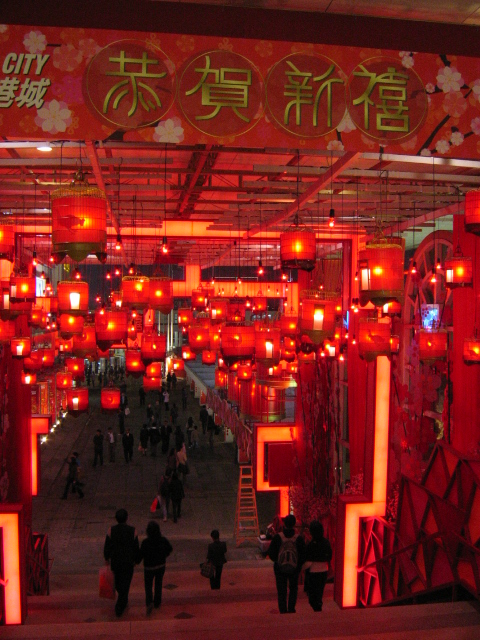 a busy walkway is decorated with many chinese lanterns