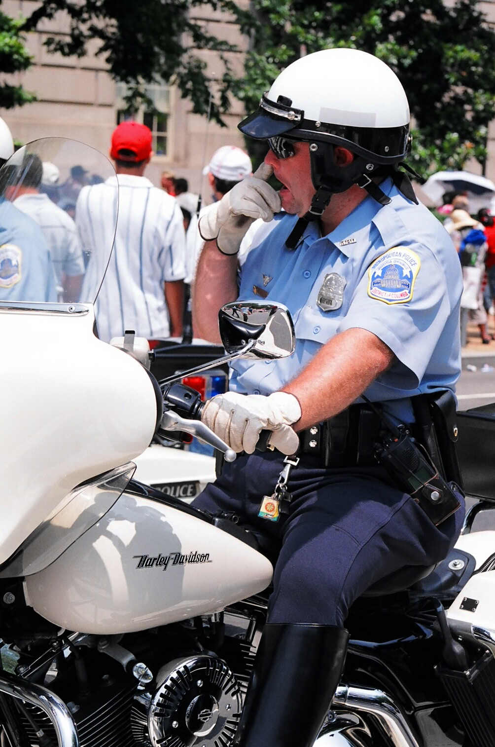 a policeman riding on the back of his motorcycle