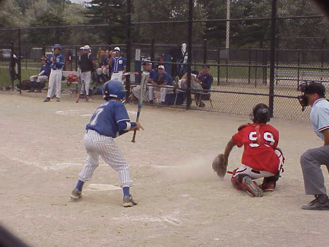 the young baseball player is about to hit a ball
