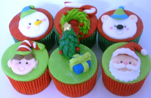 a collection of decorated cupcakes sitting on top of a table