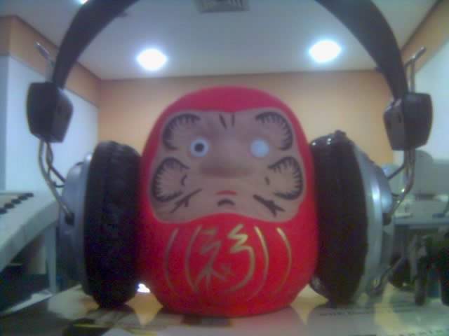headphones with an oriental character in front of a keyboard