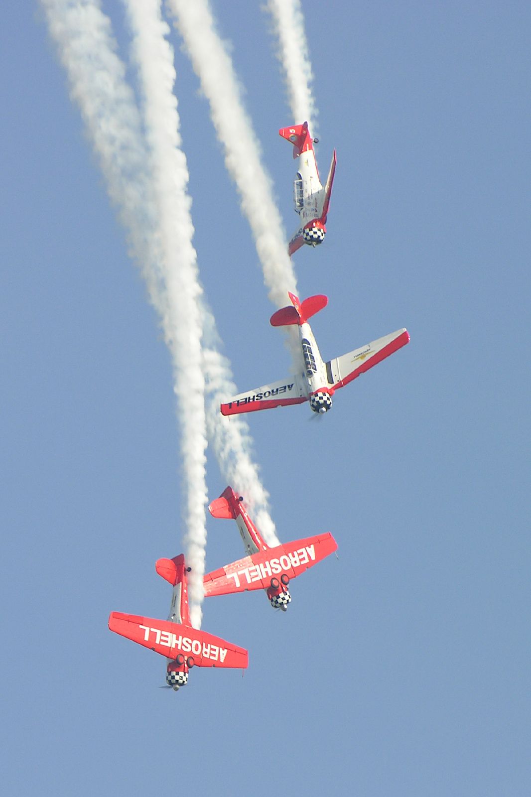 three airplanes are flying in the sky together