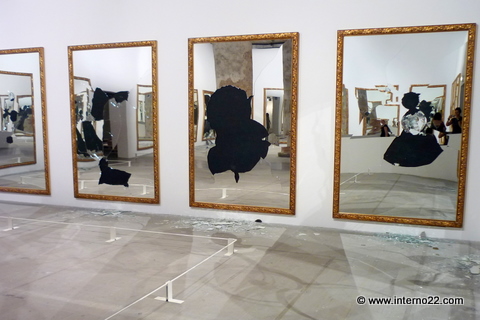 a large number of mirrors hanging on the wall