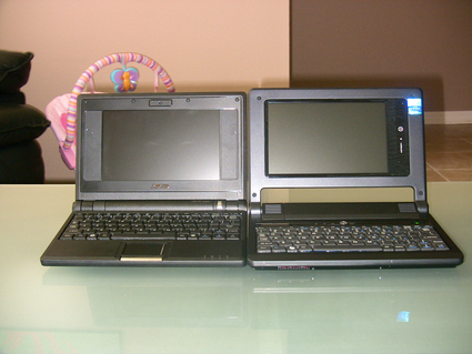 two laptops sit next to each other on a table