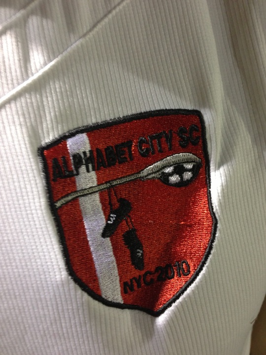a red and white shirt with a red patch on it