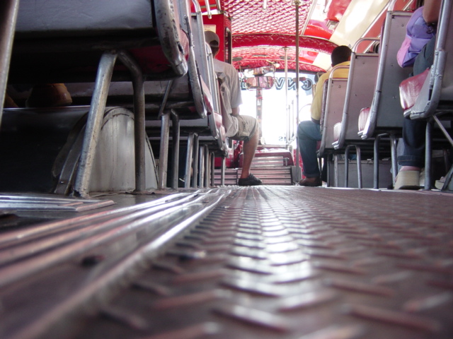 view down an empty bus's aisle from the top