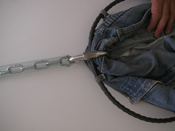 jeans are laid across a cord in the shape of a hoe