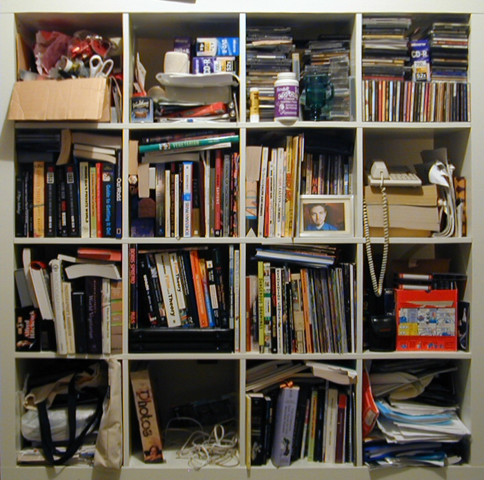 many items are stored on a shelves in a bookshelf
