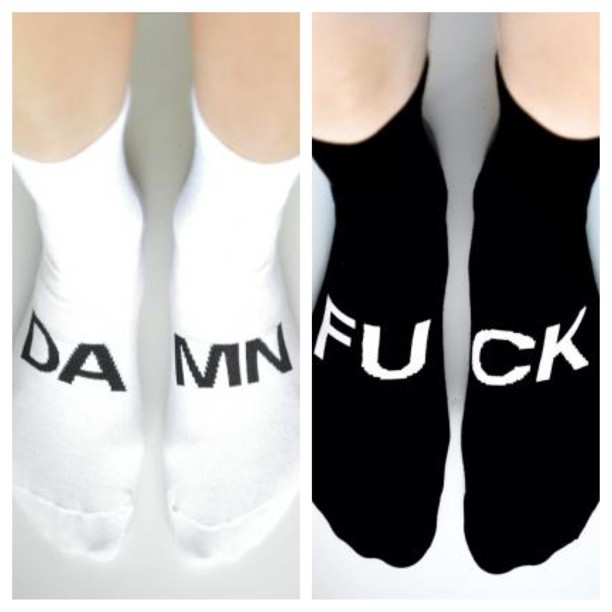 a woman's feet and their name on socks