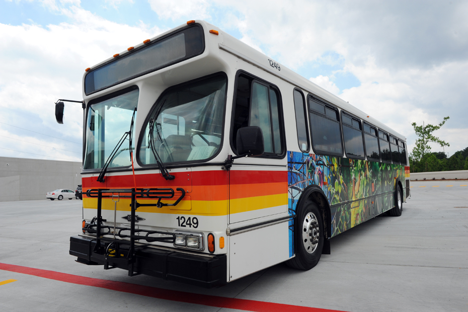 a colorful bus parked in an empty parking lot