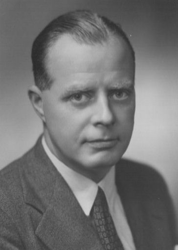 black and white po of a man in suit and tie