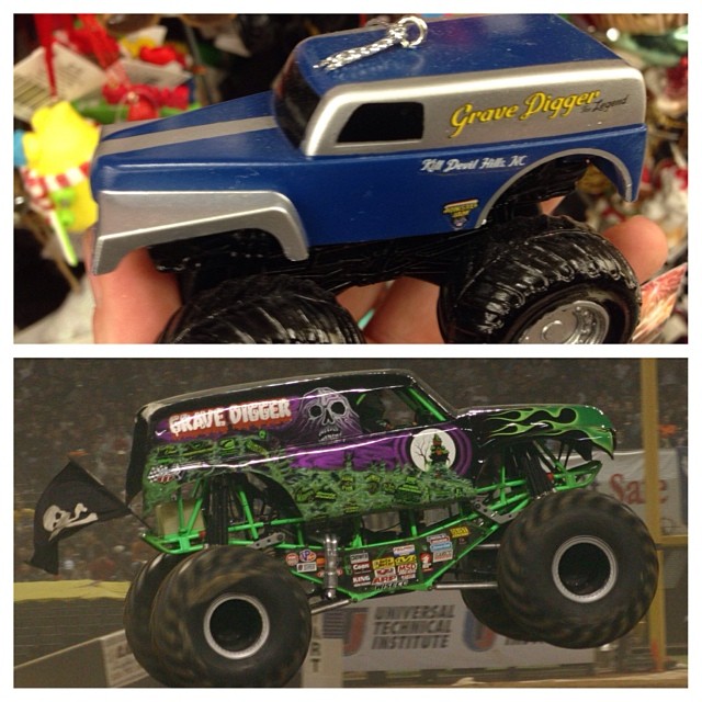 a toy monster truck is sitting next to a fake monster truck